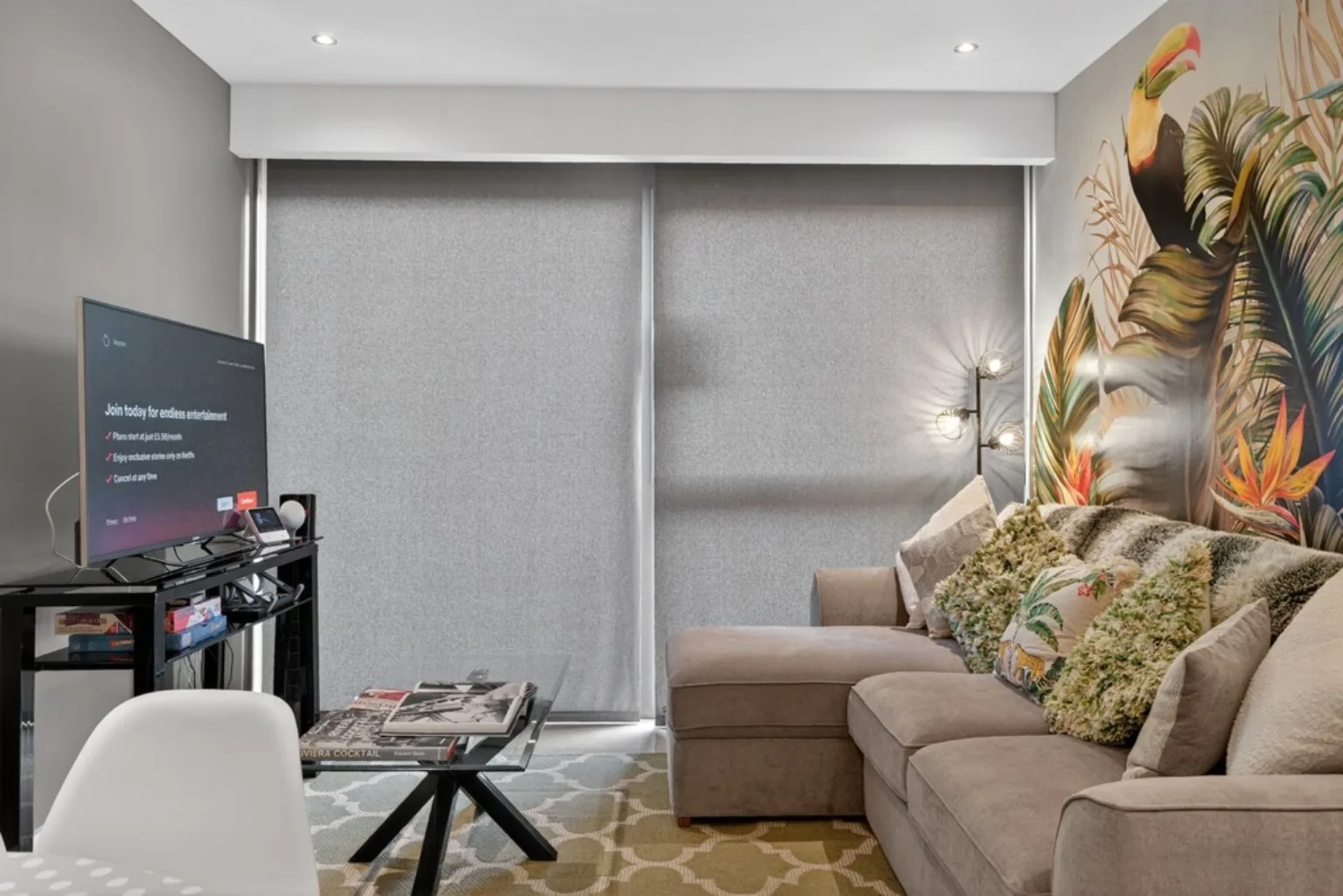 The Bird House Belfast living space with toucan mural